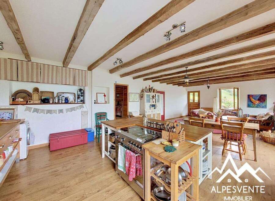This charming property boasts a rustic kitchen with a large island, perfect for cooking and entertaining.