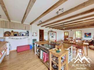 This charming property boasts a rustic kitchen with a large island, perfect for cooking and entertaining.