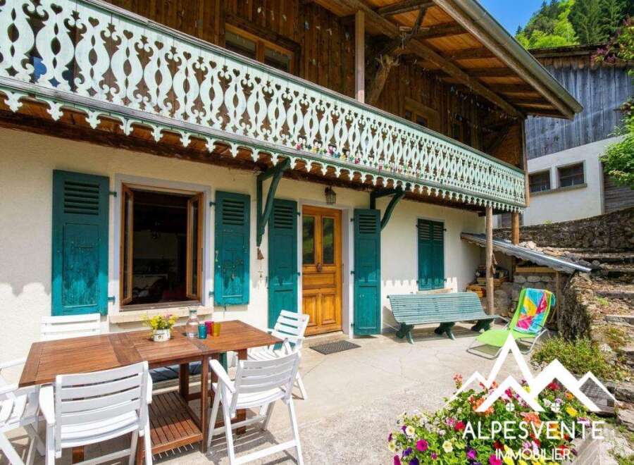 Discover the charm of this stunning property, featuring a beautifully crafted wooden balcony and vibrant turquoise shutters.