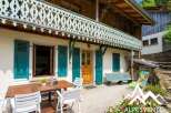 Discover the charm of this stunning property, featuring a beautifully crafted wooden balcony and vibrant turquoise shutters.