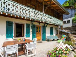 Discover the charm of this stunning property, featuring a beautifully crafted wooden balcony and vibrant turquoise shutters.