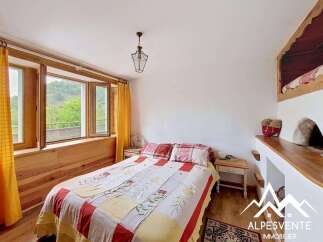 Discover the charm of this cozy bedroom, featuring a unique built-in bed and a warm, inviting atmosphere.
