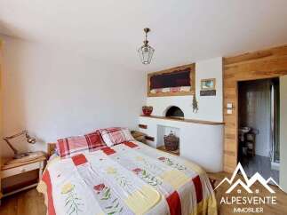 Discover the charm of this unique bedroom featuring a cozy fireplace and rustic wooden accents.