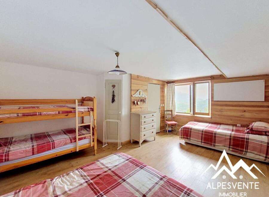This charming bedroom features a cozy bunk bed and a comfortable single bed, perfect for accommodating guests or family.
