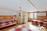 This charming bedroom features a cozy bunk bed and a comfortable single bed, perfect for accommodating guests or family.
