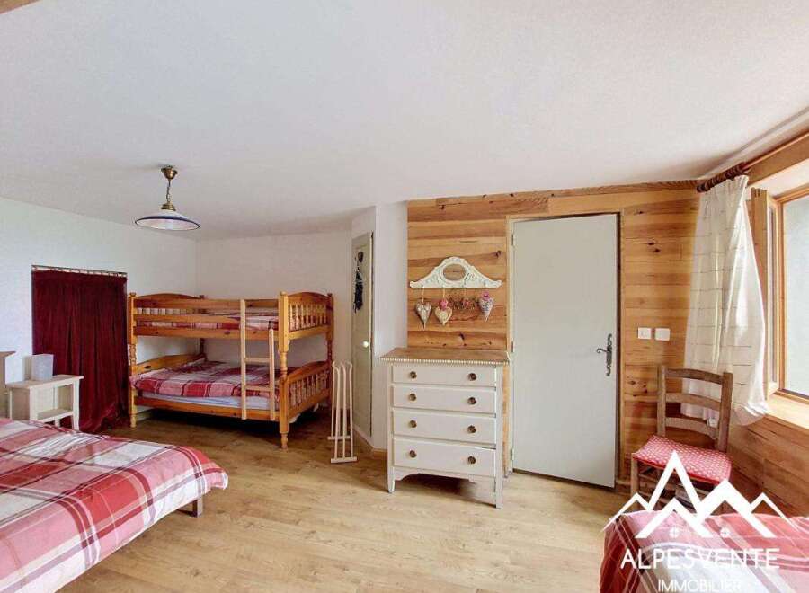 Discover this charming bedroom featuring a cozy bunk bed, perfect for accommodating guests or family.
