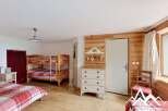 Discover this charming bedroom featuring a cozy bunk bed, perfect for accommodating guests or family.