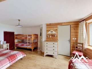 Discover this charming bedroom featuring a cozy bunk bed, perfect for accommodating guests or family.