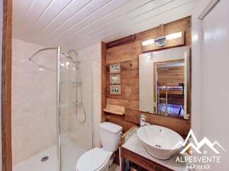 Discover this charming bathroom featuring a modern shower, a stylish sink, and a comfortable toilet.