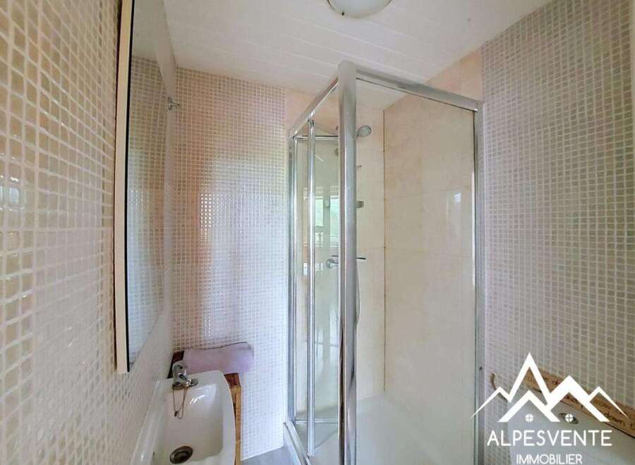 Discover this charming bathroom featuring a modern shower enclosure and a stylish sink.