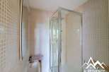 Discover this charming bathroom featuring a modern shower enclosure and a stylish sink.