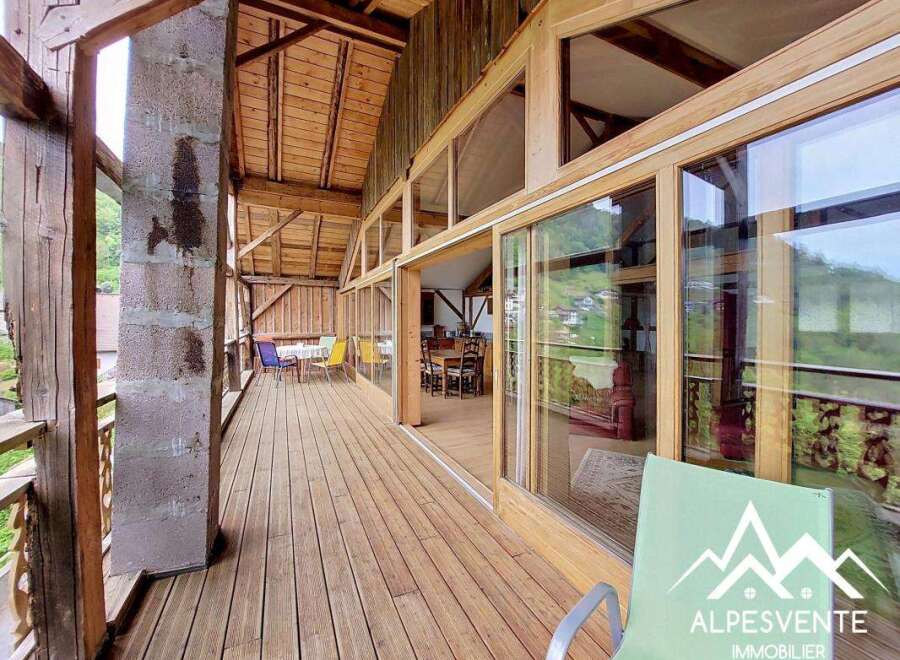 Discover the charm of this stunning property, featuring a spacious wooden deck that offers breathtaking views.