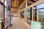 Discover the charm of this stunning property, featuring a spacious wooden deck that offers breathtaking views.