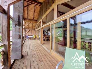 Discover the charm of this stunning property, featuring a spacious wooden deck that offers breathtaking views.