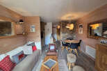 This cozy living space features a rustic design with wooden paneling and a warm ambiance.