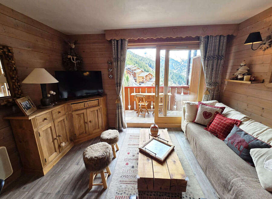 Experience the charm of this cozy mountain retreat, featuring warm wooden interiors and stunning views.