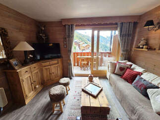 Experience the charm of this cozy mountain retreat, featuring warm wooden interiors and stunning views.