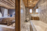 Experience luxury living in this stunning property featuring a beautifully designed bathroom and a cozy bedroom.