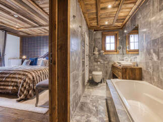 Experience luxury living in this stunning property featuring a beautifully designed bathroom and a cozy bedroom.