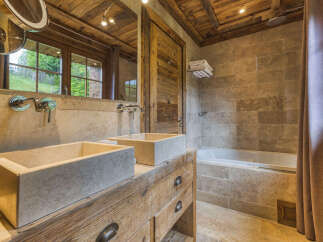 Experience rustic luxury in this stunning bathroom.