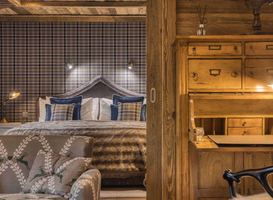 Experience rustic charm and cozy luxury in this beautifully appointed bedroom.