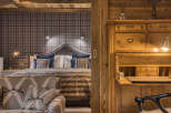 Experience rustic charm and cozy luxury in this beautifully appointed bedroom.