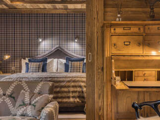 Experience rustic charm and cozy luxury in this beautifully appointed bedroom.