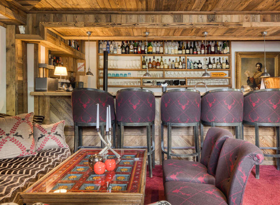 Experience rustic luxury in this charming chalet bar area, featuring a fully stocked bar with a wide selection of spirits and glassware.