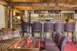 Experience rustic luxury in this charming chalet bar area, featuring a fully stocked bar with a wide selection of spirits and glassware.
