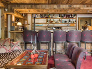 Experience rustic luxury in this charming chalet bar area, featuring a fully stocked bar with a wide selection of spirits and glassware.