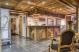 Experience rustic charm in this hotel lobby, featuring a stunning wooden reception desk with intricate geometric patterns.
