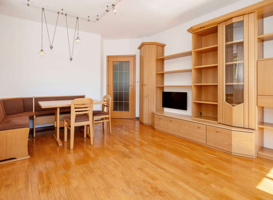 This inviting living space features warm wooden floors and built-in cabinetry, creating a cozy and functional atmosphere.