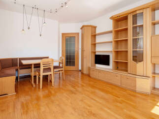 This inviting living space features warm wooden floors and built-in cabinetry, creating a cozy and functional atmosphere.