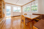 This bright and airy dining area features a beautiful wooden table and chairs, perfect for enjoying meals with family and friends.