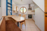 This charming kitchen features a unique design with a round window offering scenic views.