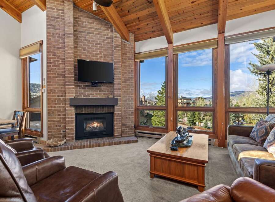 Experience luxury living in this stunning property featuring a cozy fireplace and expansive windows that frame breathtaking views.