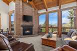 Experience luxury living in this stunning property featuring a cozy fireplace and expansive windows that frame breathtaking views.