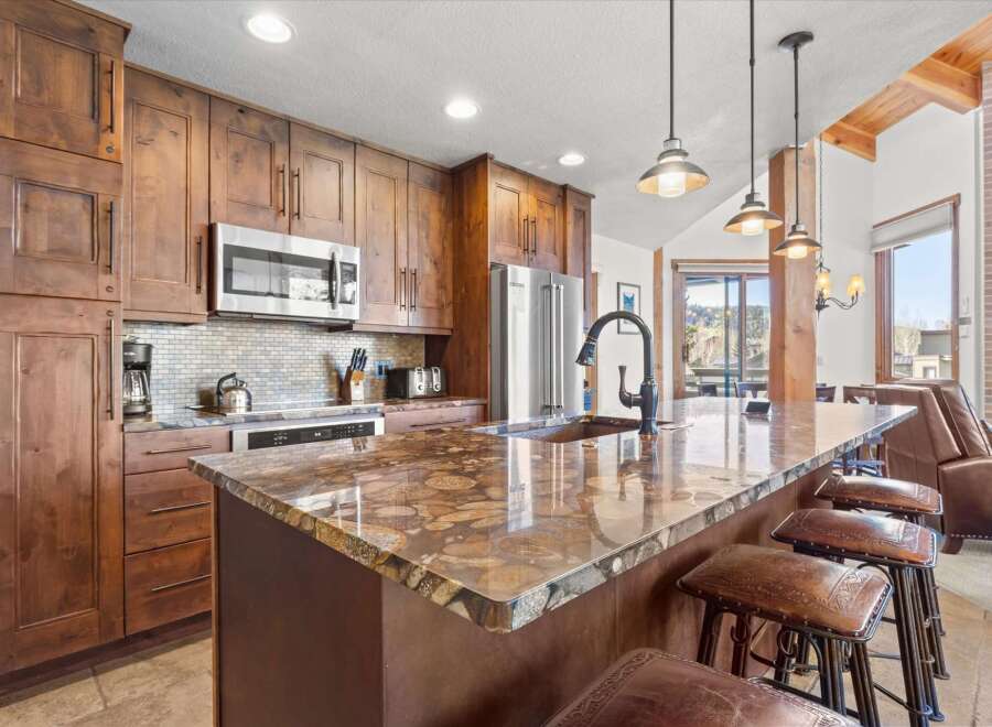 This stunning kitchen boasts custom cabinetry, stainless steel appliances, and a beautiful granite countertop.