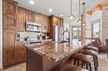 This stunning kitchen boasts custom cabinetry, stainless steel appliances, and a beautiful granite countertop.