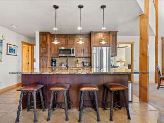 This stunning kitchen features a beautiful island with seating, perfect for entertaining or casual dining.