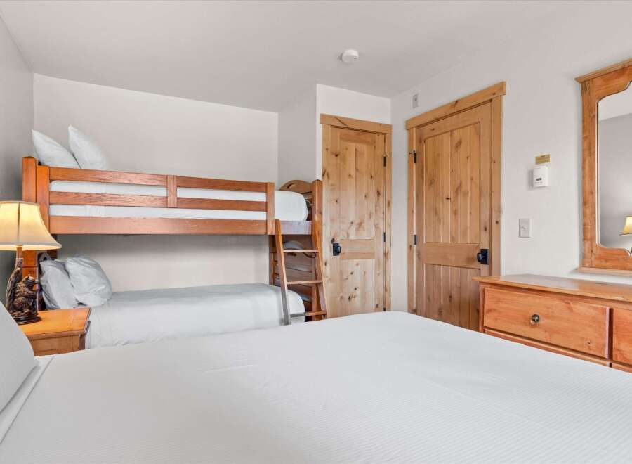 This cozy bedroom features a bunk bed, perfect for accommodating guests or family.