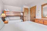 This cozy bedroom features a bunk bed, perfect for accommodating guests or family.
