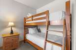 This cozy bedroom features a charming bunk bed, perfect for accommodating guests or family members.