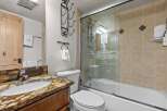 Step into this beautifully designed bathroom, featuring a stylish vanity with a unique countertop and a sleek, modern sink.
