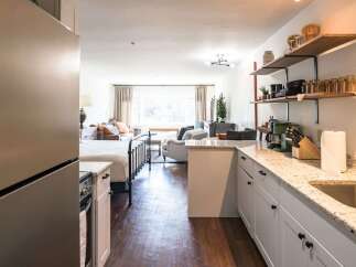 Discover the charm of this beautifully designed property, featuring a modern kitchen with granite countertops and ample storage.