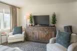This cozy living room features a rustic wooden cabinet that serves as a stylish entertainment center.