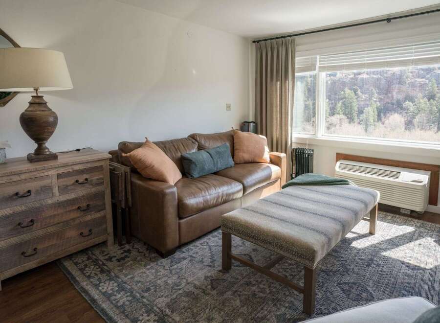 This cozy living space features a comfortable leather sofa, perfect for relaxing after a long day.