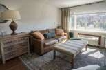 This cozy living space features a comfortable leather sofa, perfect for relaxing after a long day.