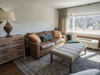 This cozy living space features a comfortable leather sofa, perfect for relaxing after a long day.