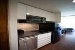 Discover modern living in this stylish studio apartment! The kitchen boasts sleek, white cabinetry, a stainless steel dishwasher, and a built-in microwave, perfect for effortless meal prep.